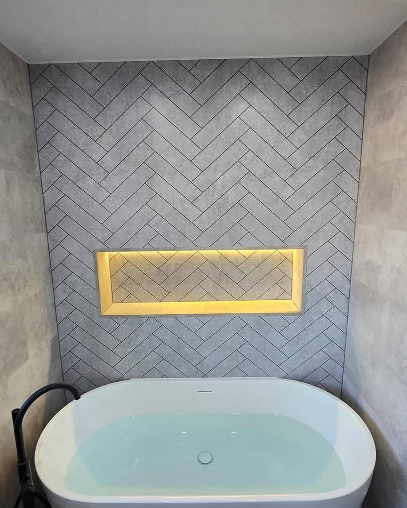 Newly fitted bathroom in Gosforth with freestanding bath and herringbone tiling